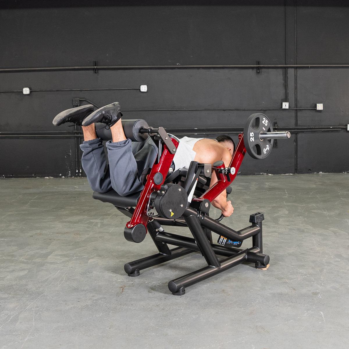 Person performing leg extension and prone leg curl on Power Leverage V2 machine.