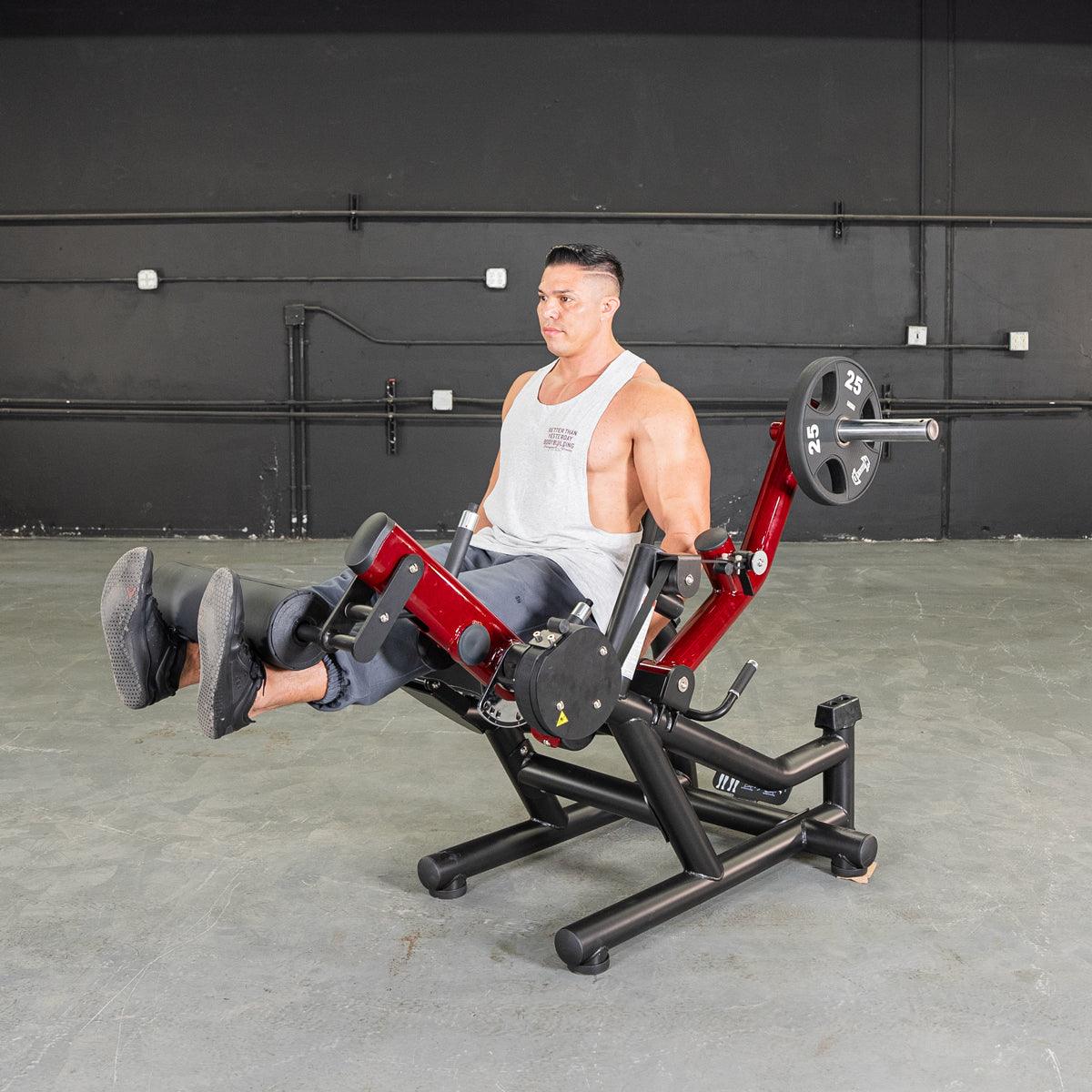 Man on a Power Leverage V2 leg extension/prone leg curl machine.