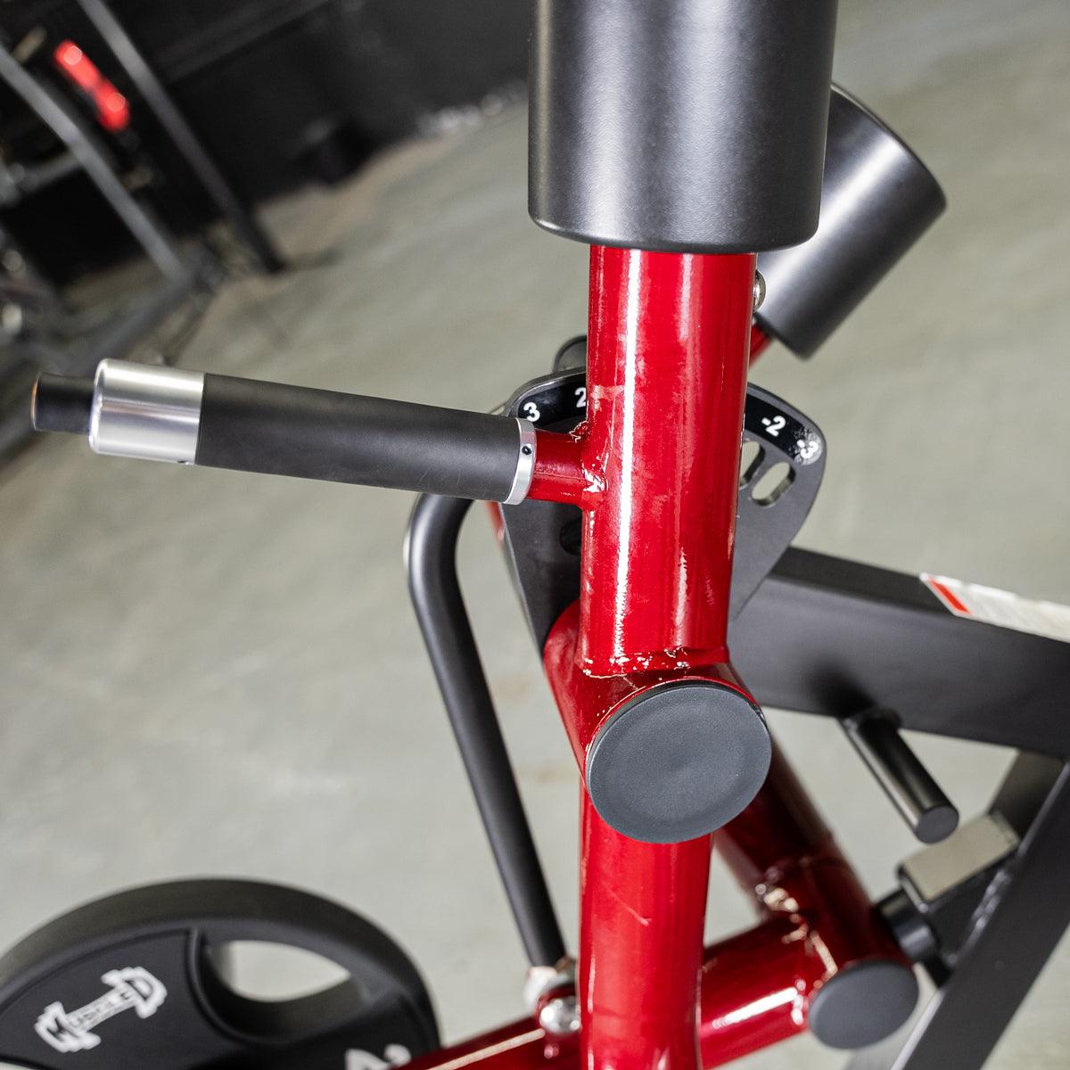 Close-up of red Power Leverage V2 leg-extension lever on exercise bike.