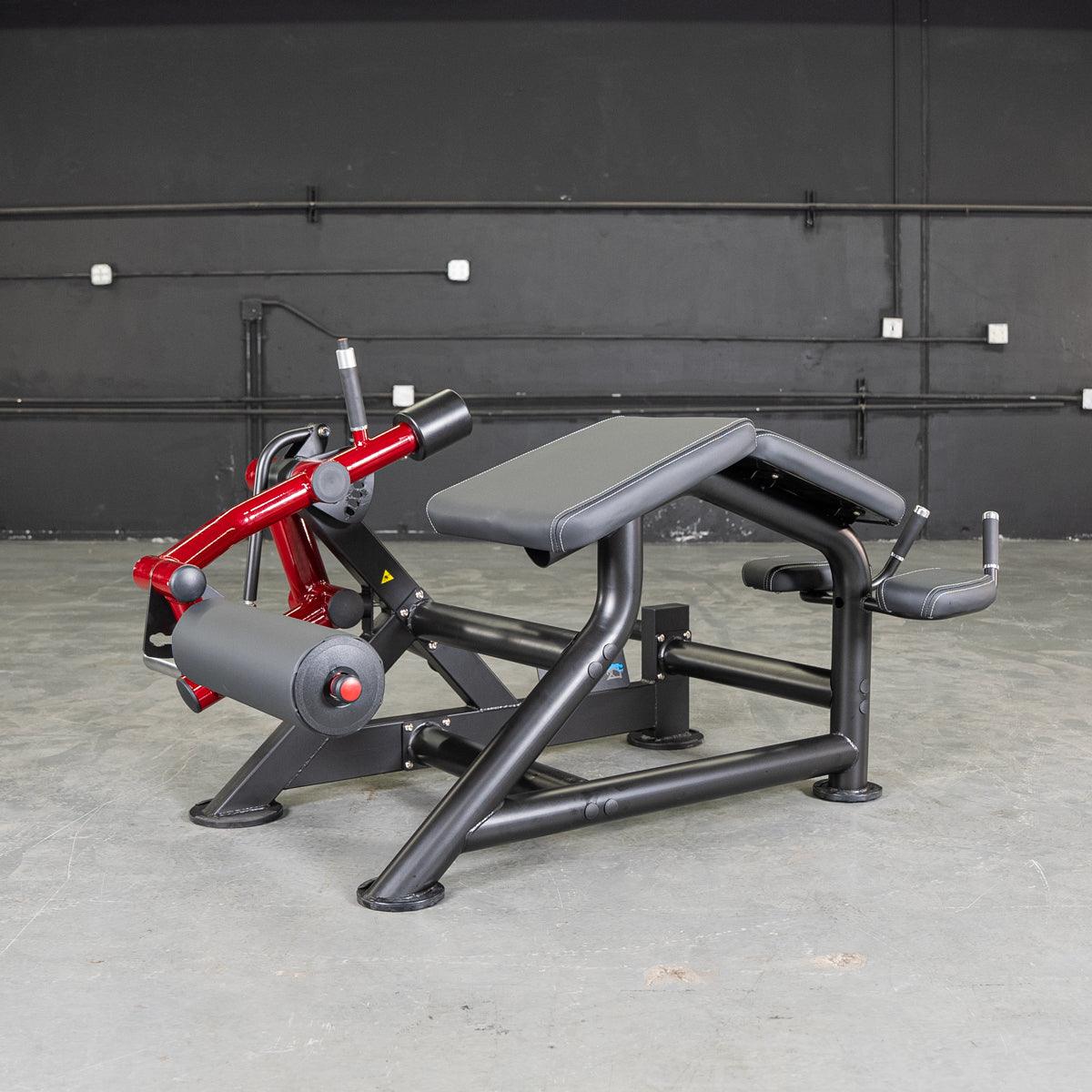 Power Leverage V2 Prone Leg Curl machine with red frame and padded components.