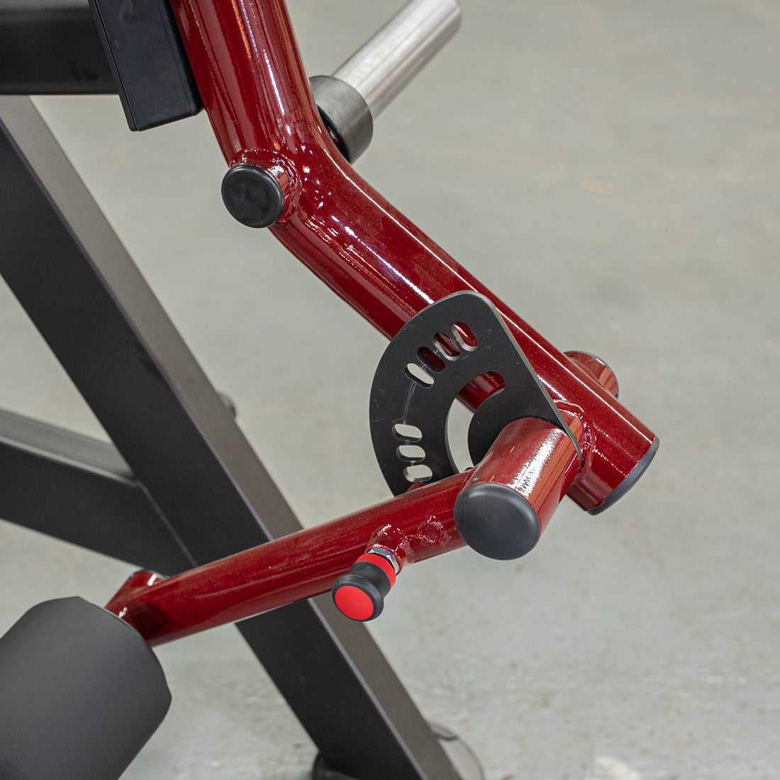 Power Leverage V2 Reverse Hyper machine in red with adjustment plate and pins.