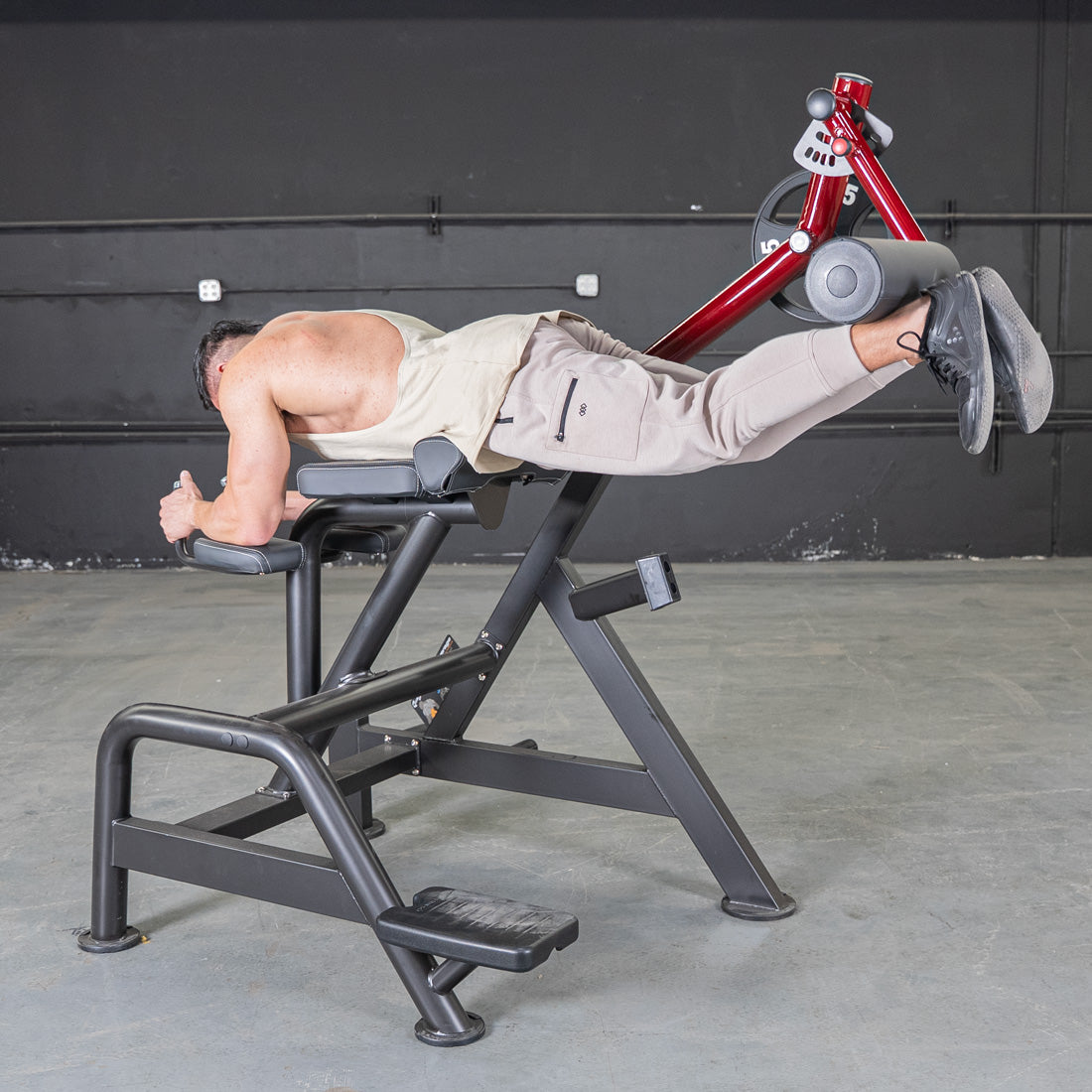 Man exercising on Power Leverage V2 Reverse Hyper machine.