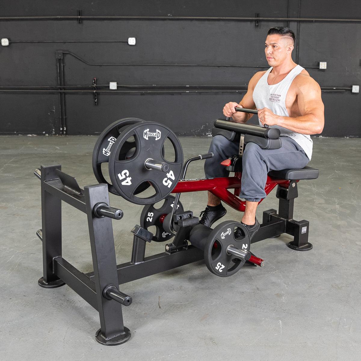 Man using a Power Leverage V2 seated calf raise machine with weights.