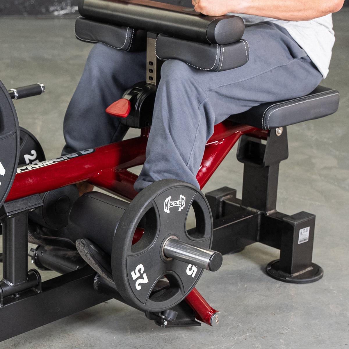 Person seated on Power Leverage V2 Seated Calf/Tib machine with weight plate.