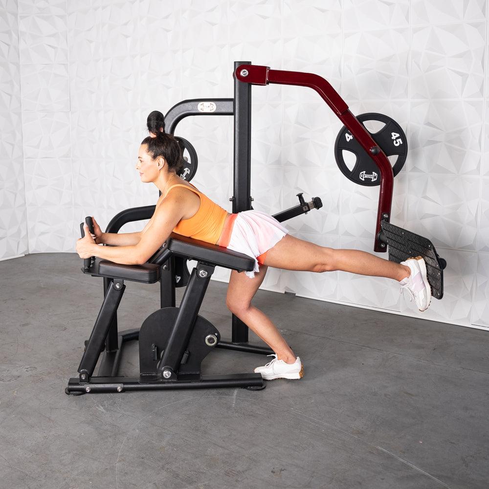 Woman using Pro-Strength Booty Shaper machine for glute workout.