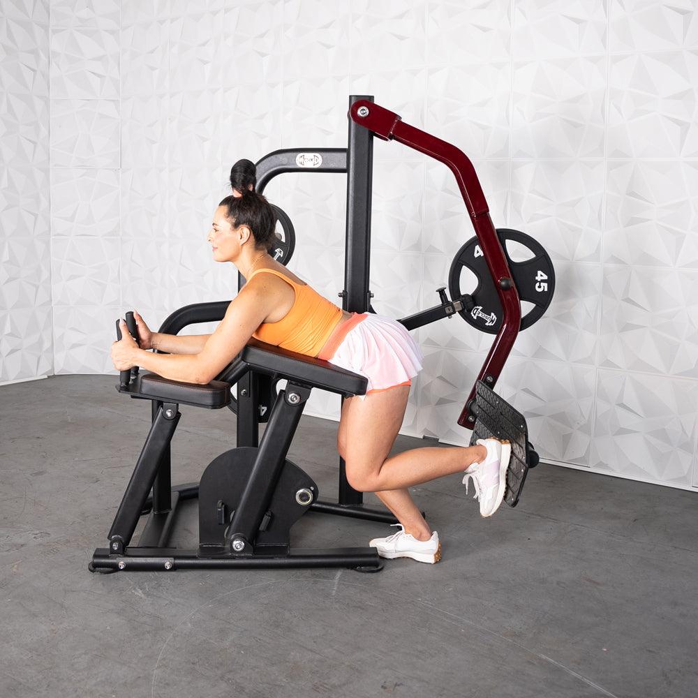 Woman using Pro-Strength Booty Shaper machine for glute workout.