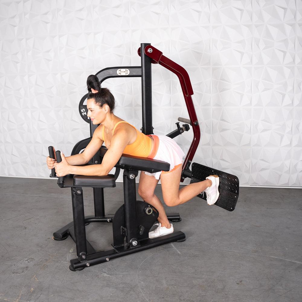 Woman using Pro-Strength Booty Shaper gym machine.