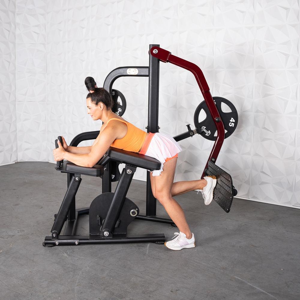 Woman on Pro-Strength Booty Shaper machine performing glute workout.