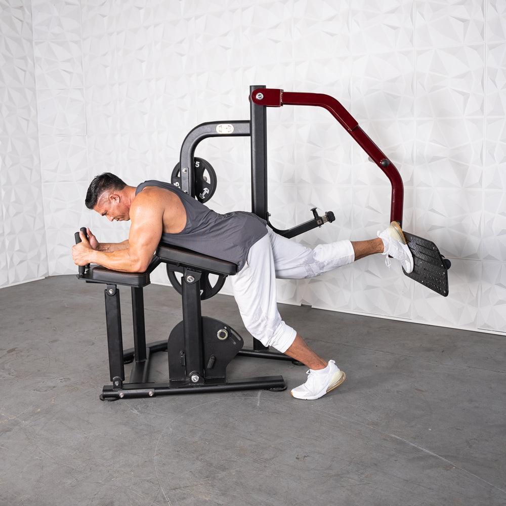 Man using Pro-Strength Booty Shaper machine for glute workout.