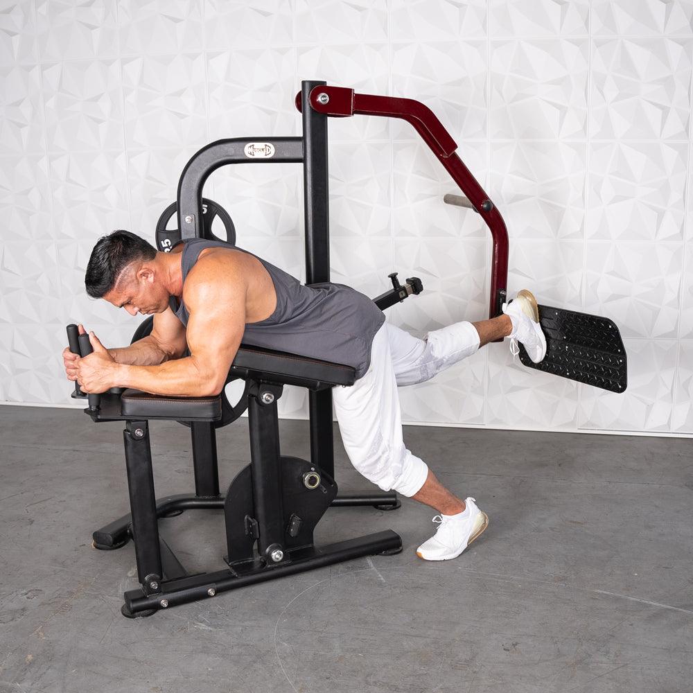 Man using Pro-Strength Booty Shaper machine for leg/booty workout.