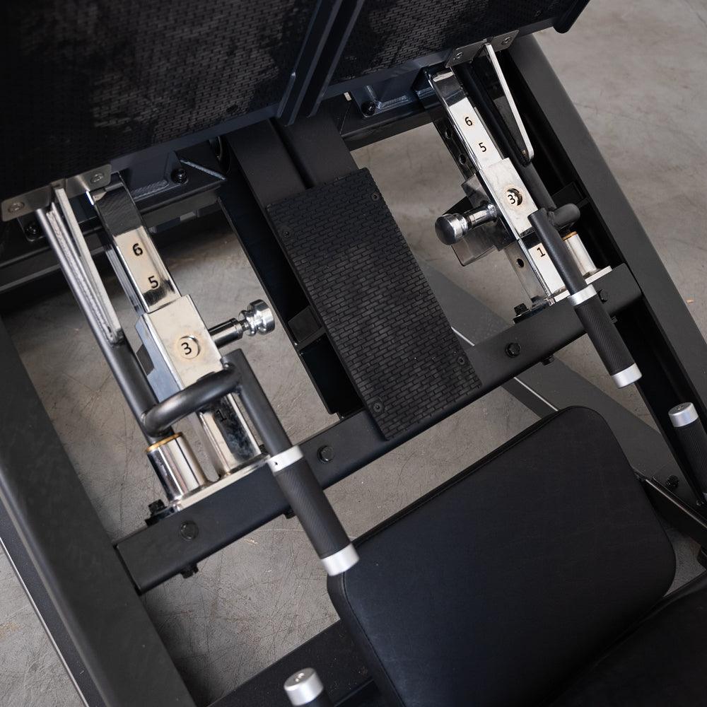 ProStrength dual leg press machine with adjustable levers and padded seat.