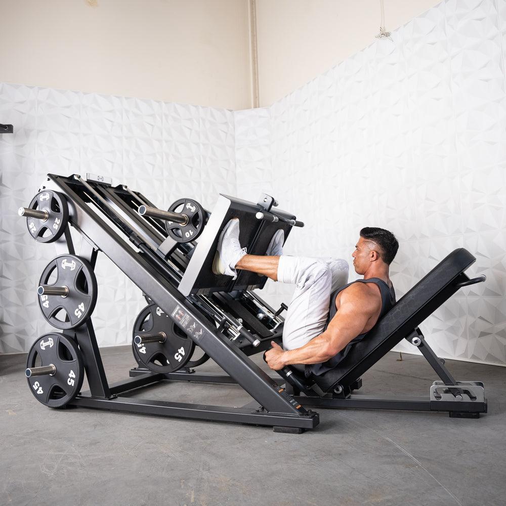 Man performing leg press on a ProStrength dual leg press machine with weights.