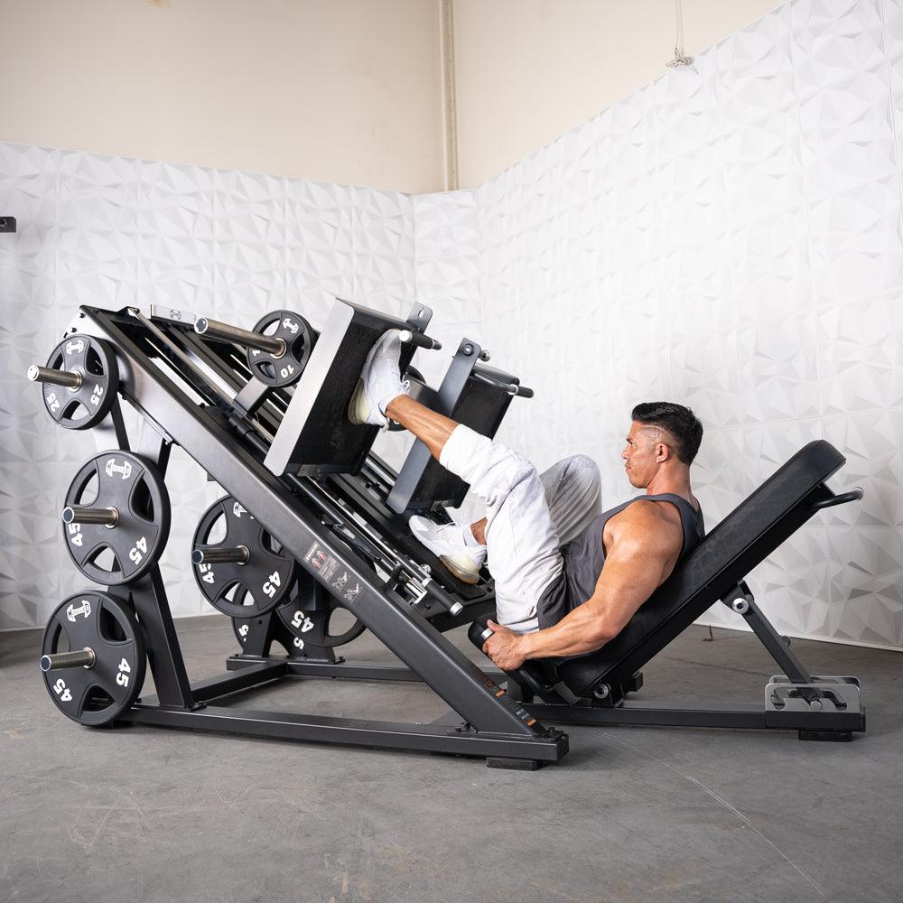 Man on ProStrength Dual Leg Press machine in gym.