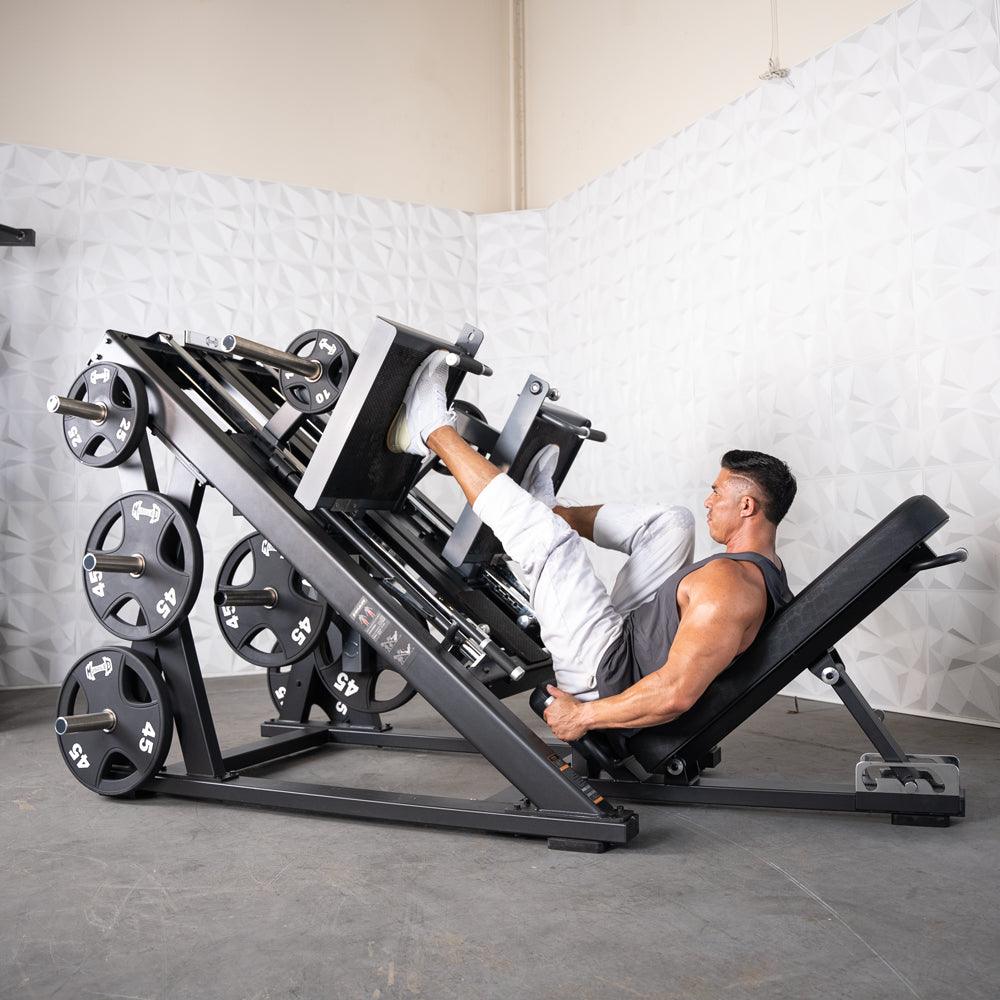 Man using ProStrength dual leg press machine with stacked weights in gym.