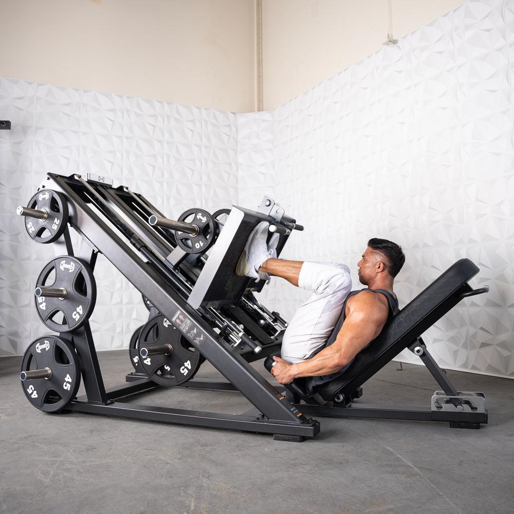 Man using ProStrength dual leg press machine in gym.