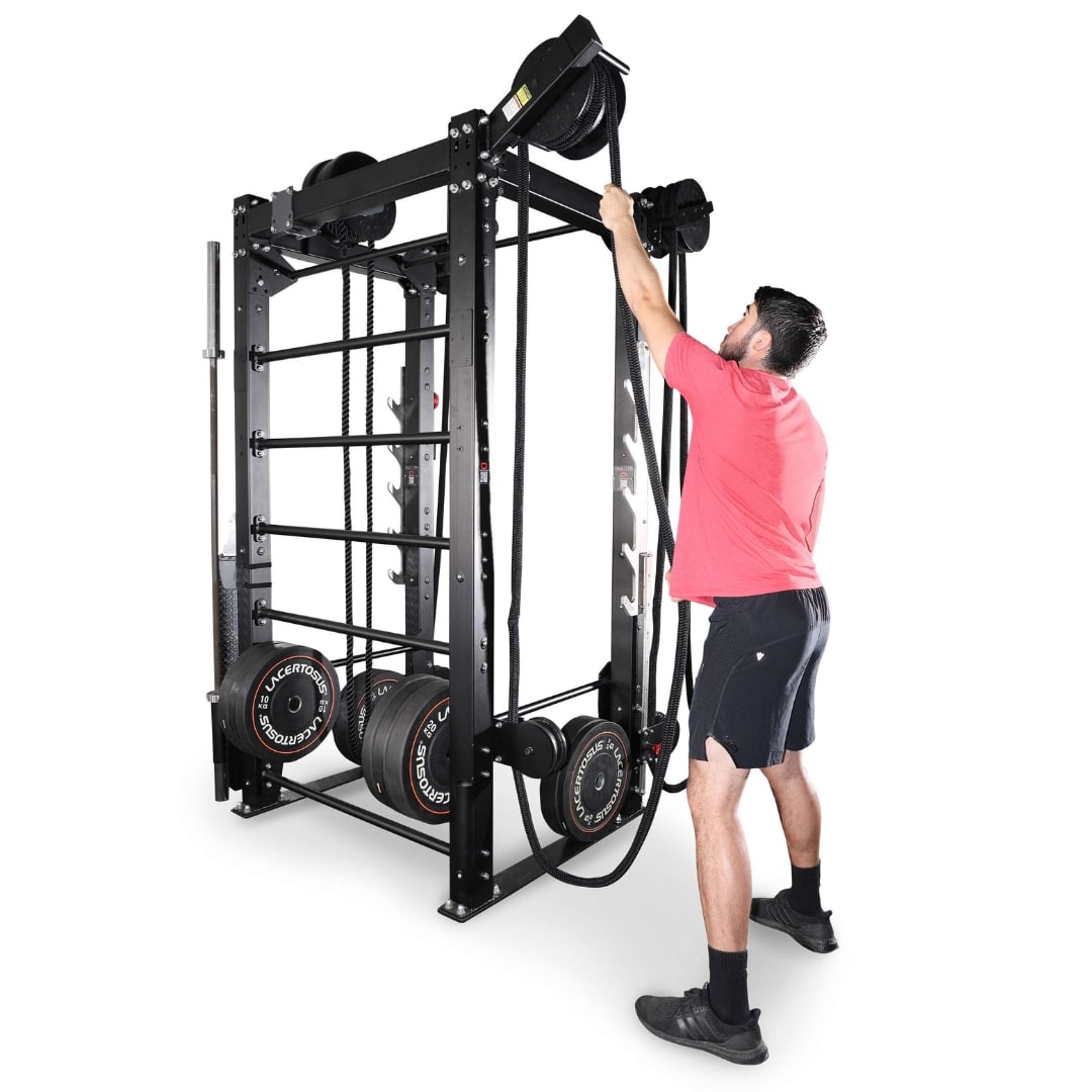 Man using black functional trainer with ropes and weights for strength training.