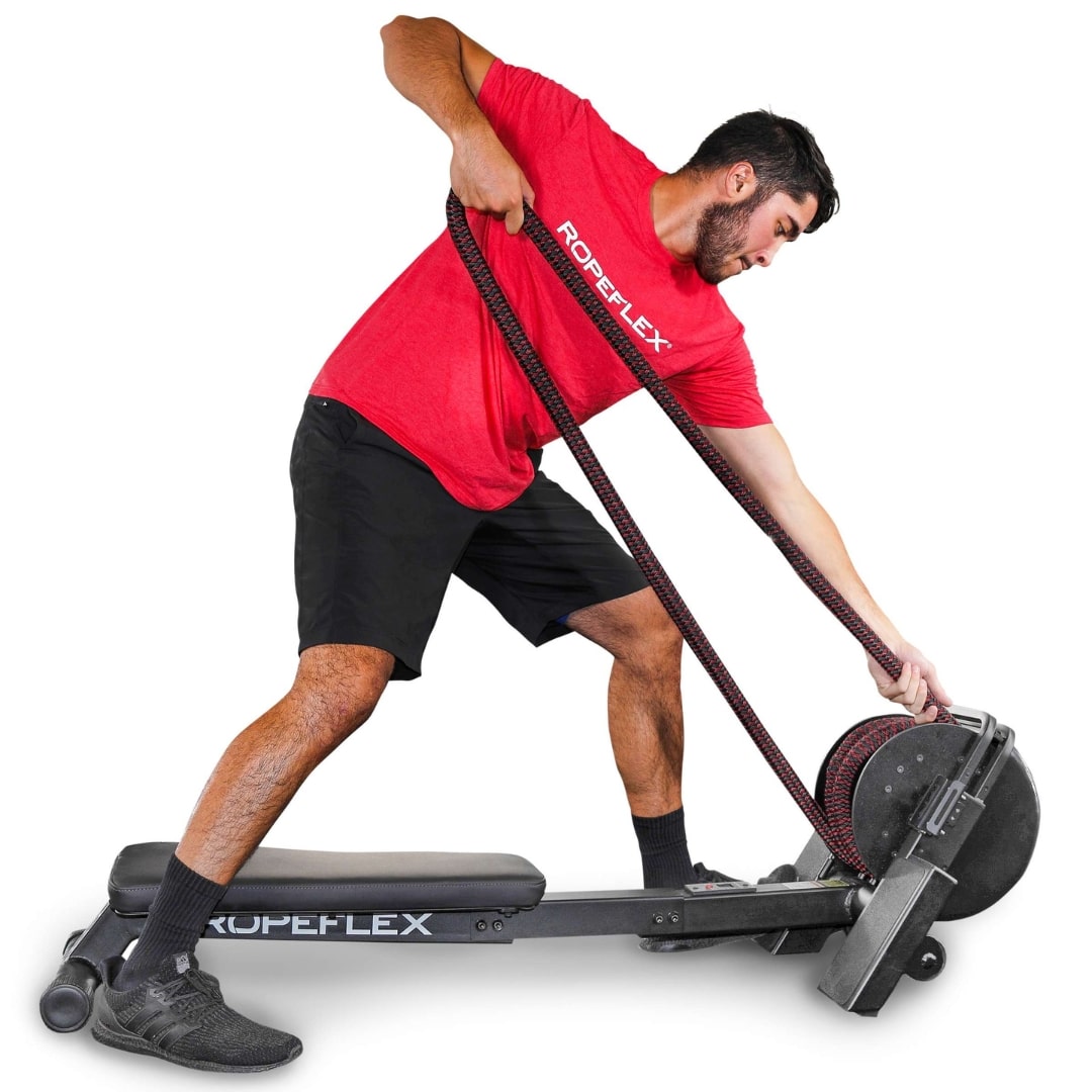 Man using Ropeflex rope trainer in red shirt for fitness workout.
