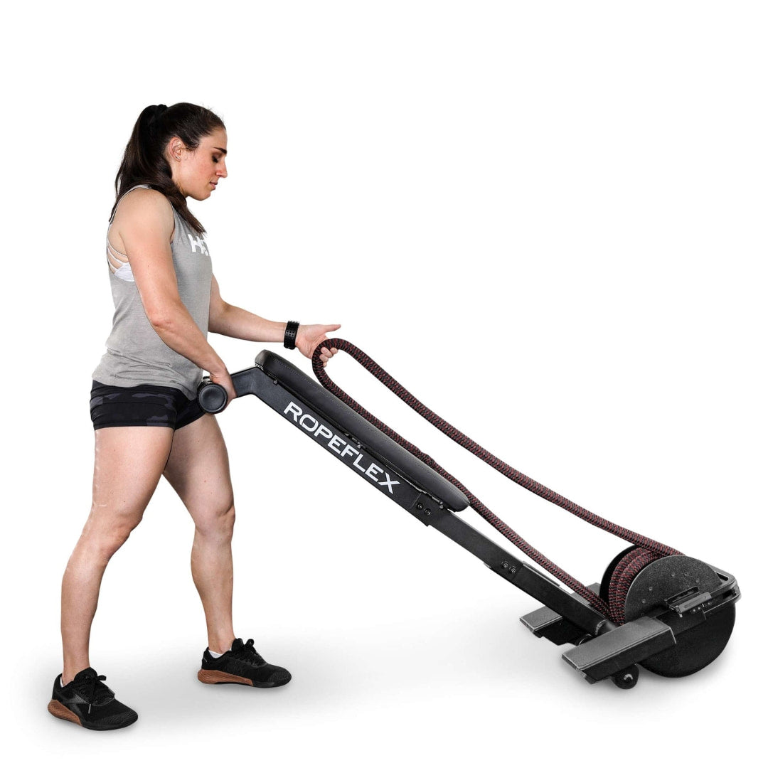 Woman using Ropeflex rope trainer, black, for upper body workout.