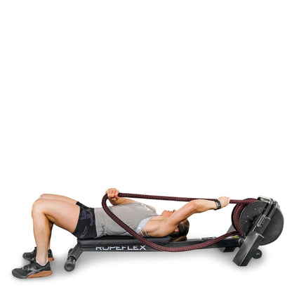 Woman exercising on Ropeflex rope trainer, wearing gray tank top and black shorts.