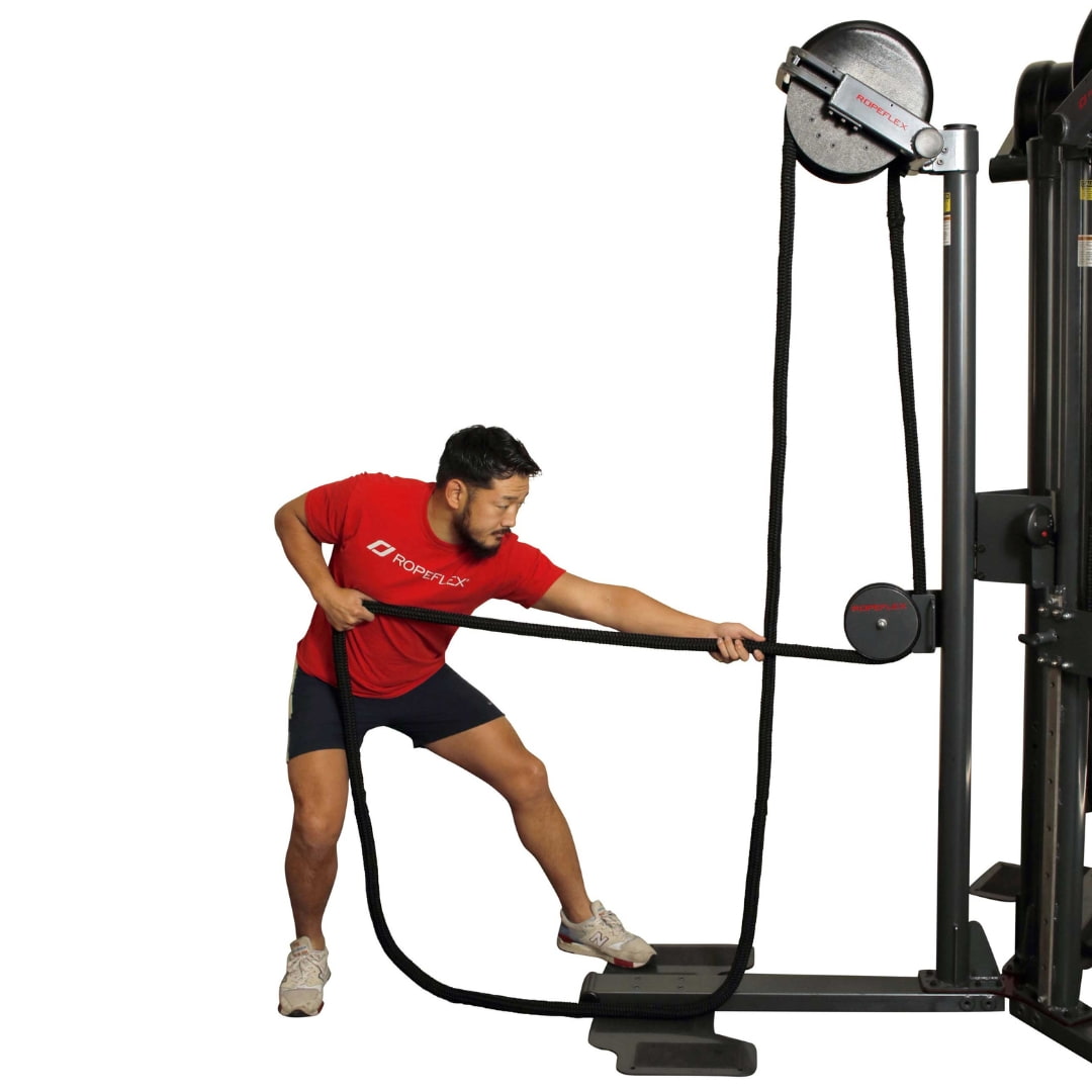 Man exercises with Ropeflex machine, pulling black rope.