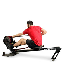 Man exercising on ROPEFLEX RX4400 rope trainer, wearing a red shirt.