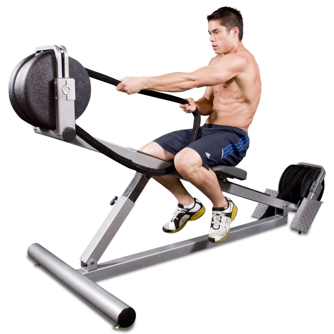 Man using a rowing exercise machine with resistance bands in a home gym setting.