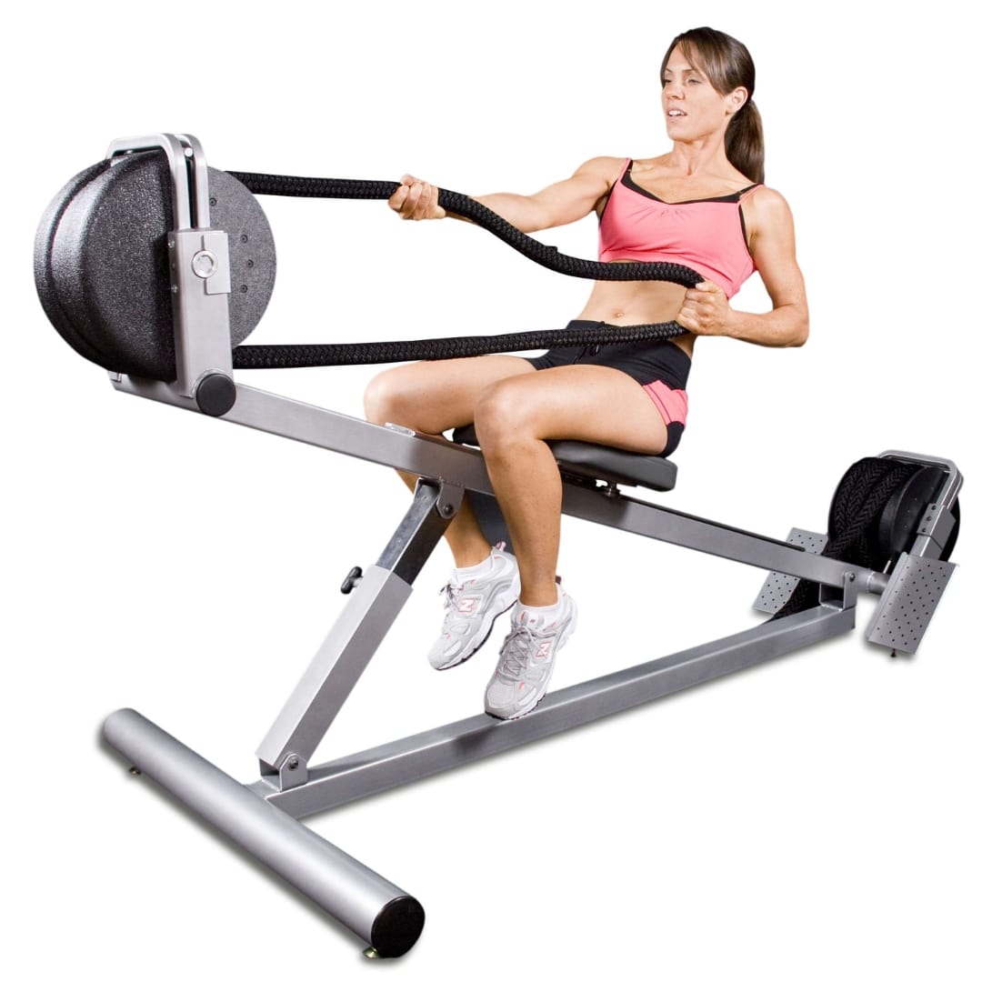 Woman using a rope pull machine in pink workout attire for strength training.