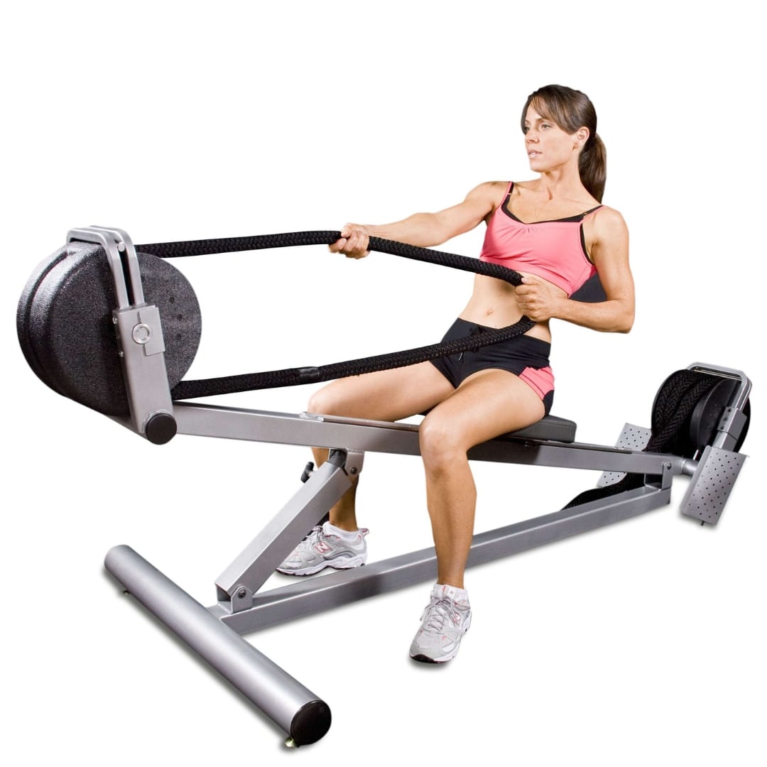 Woman using a black and silver seated row exercise machine for fitness.