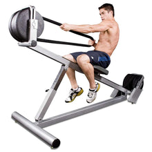 Man using a rope pull machine for strength training, showcasing fitness equipment in action.