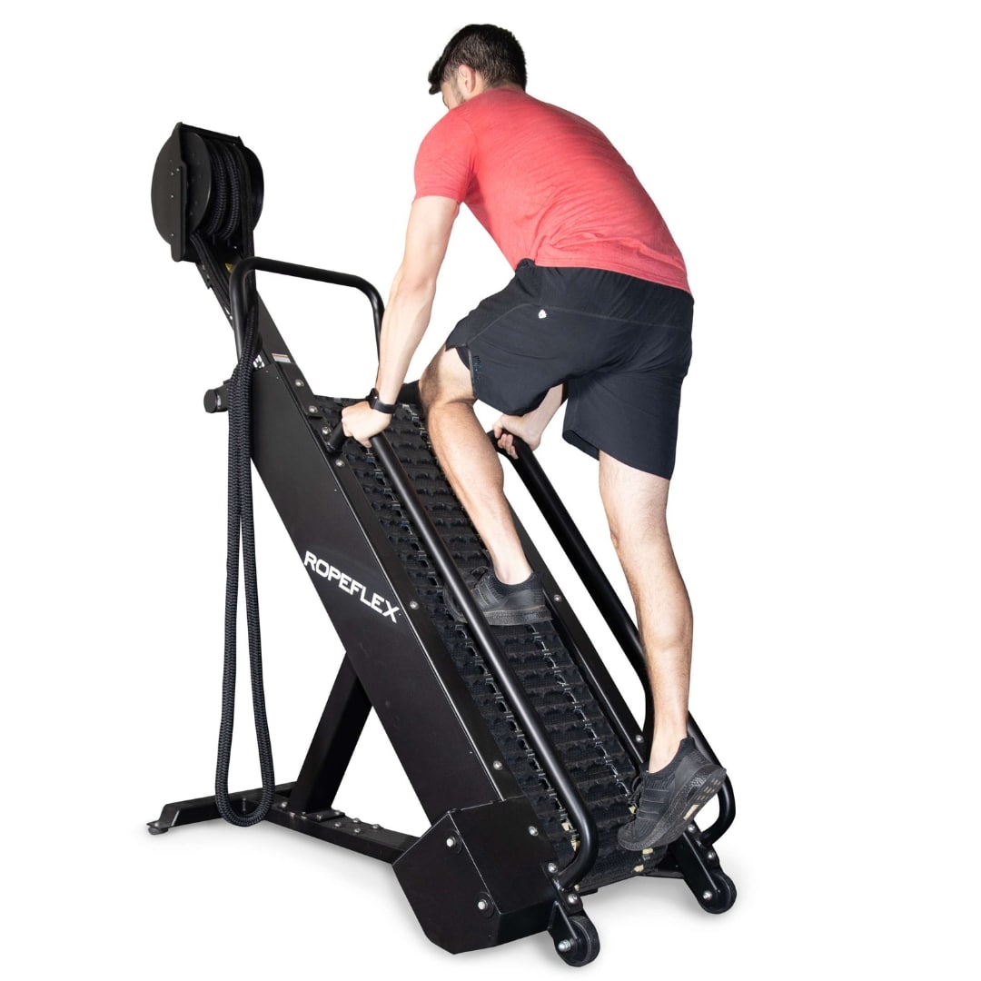 Man using black ROPEFLEX climbing machine for fitness workout.