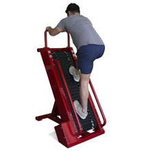 Man exercising on red Jacob's Ladder cardio machine.