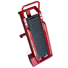 Red stair climbing dolly with rubber tracks for easy transport.