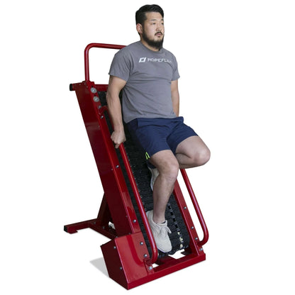Man using red Ropeflex climbing machine for fitness workout.