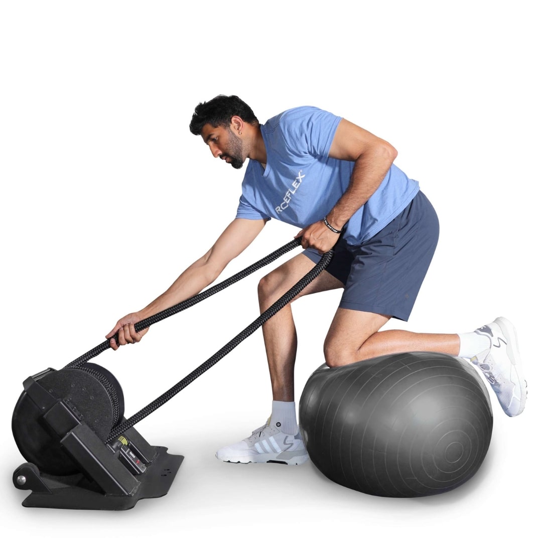 Man using Ropeflex exercise machine on a stability ball.