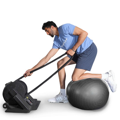 Man using Ropeflex exercise machine on a stability ball.