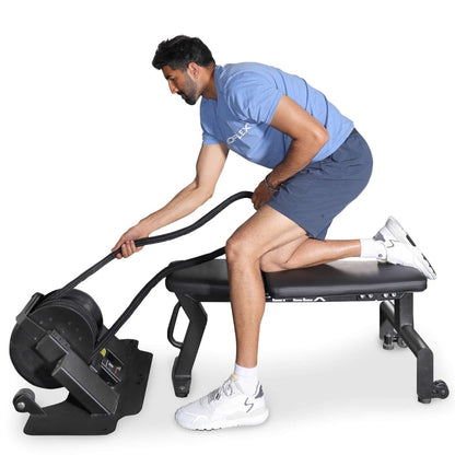 Man using Teeter Power10 elliptical rower wearing blue shirt and shorts.