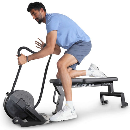 Man using ROPEFLEX exercise machine on bench for upper body workout.