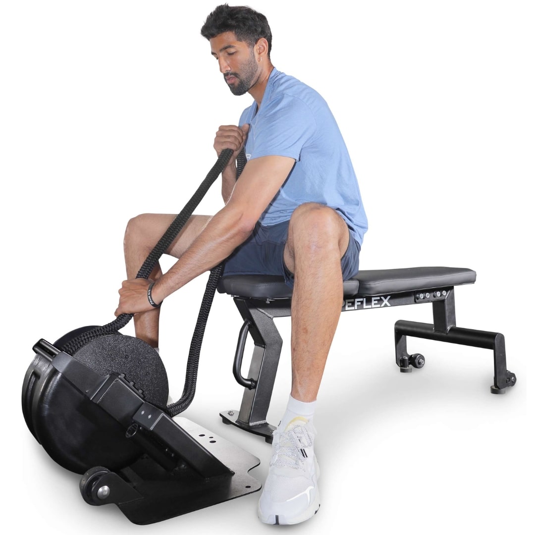 Man using a black Reflex rope trainer on a workout bench, wearing a blue shirt and white sneakers.