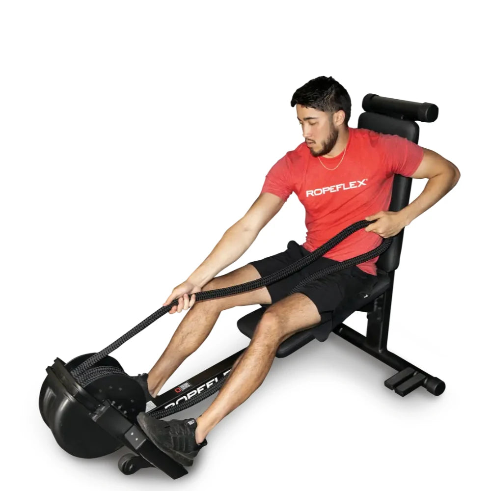 Man using Ropeflex training machine in red shirt, seated on a black exercise bench.