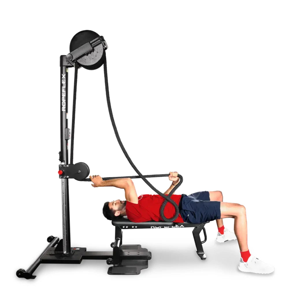 Man exercises on Ropeflex RX2300, using black resistance rope while lying on a bench.
