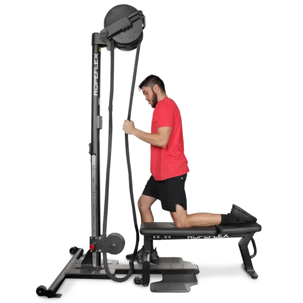 Man exercising on black ROPEFLEX rope trainer, wearing a red shirt and black shorts.