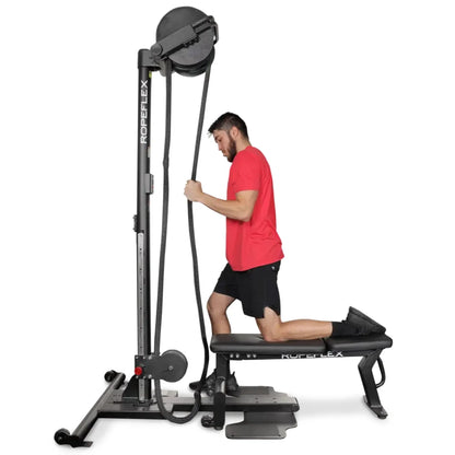 Man exercising on black ROPEFLEX rope trainer, wearing a red shirt and black shorts.