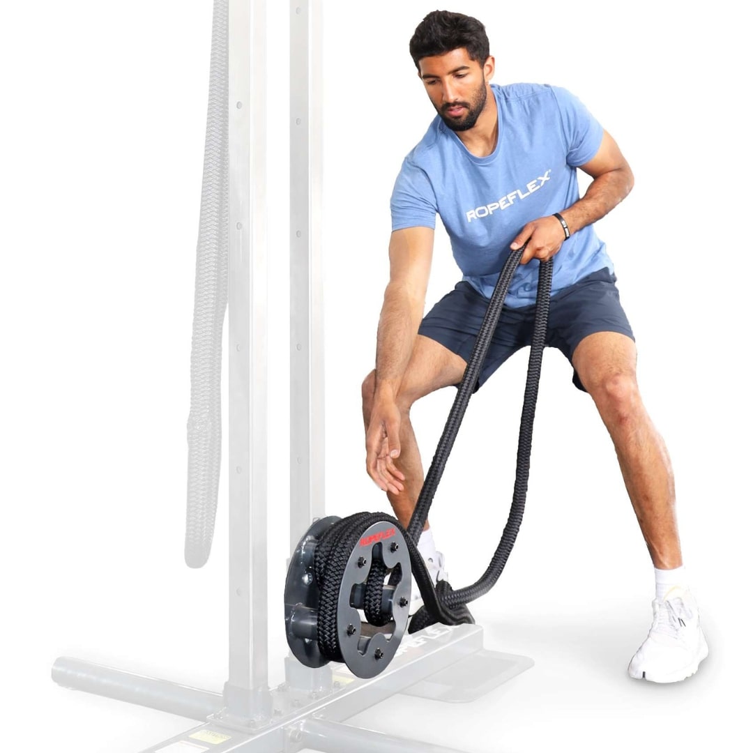 Man using Ropeflex exercise machine with black ropes.