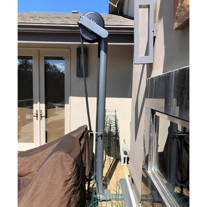 Starlink satellite dish mounted on house exterior near patio doors.