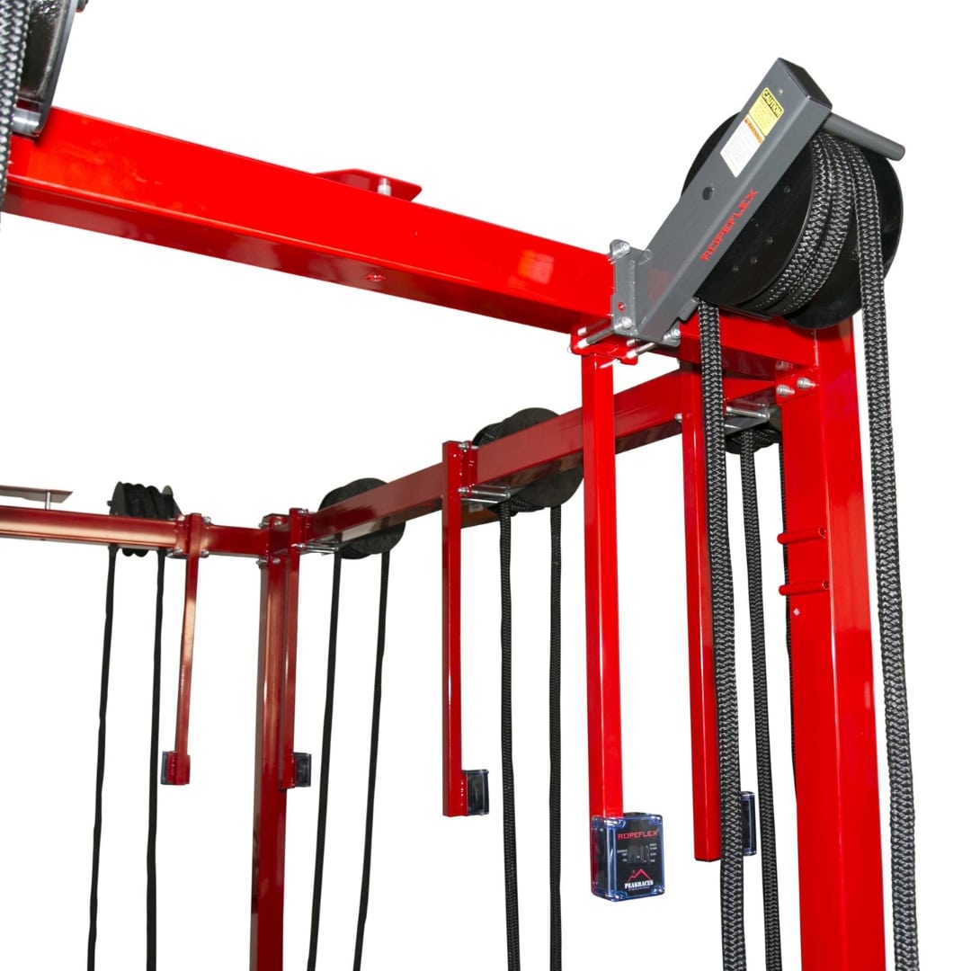 Red Powerflex gym equipment with black ropes for resistance training.