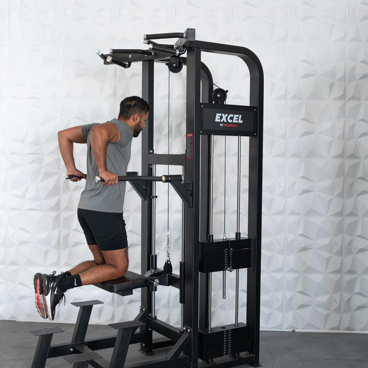 Man using Excel dip machine for tricep workout in gym.