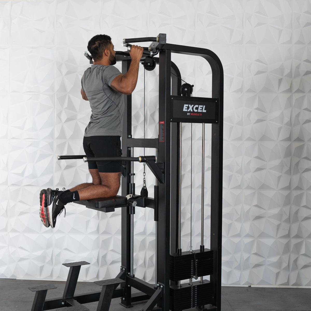 Man using Excel by Muscle D dip assist machine in gym.