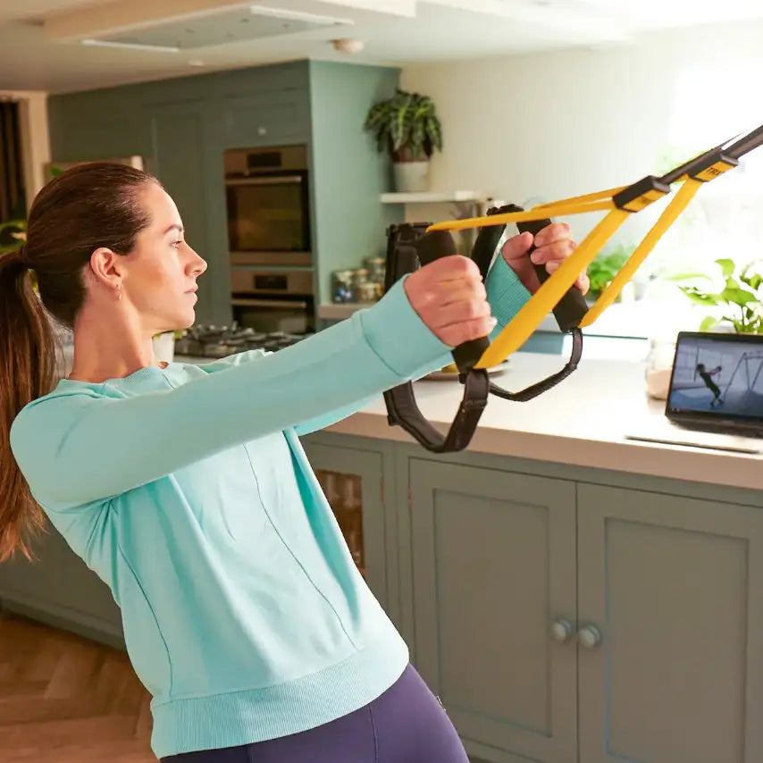 TRX Home2 System – straps neatly coiled beside the compact drawstring pouch for travel fitness