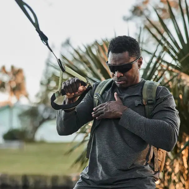 TRX Pro4 Suspension Trainer – camo suspension straps coiled to highlight rugged stitching and TRX logo tag