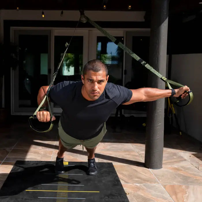 TRX Pro4 Suspension Trainer – angled view of camo straps and handles emphasizing textured rubber grips